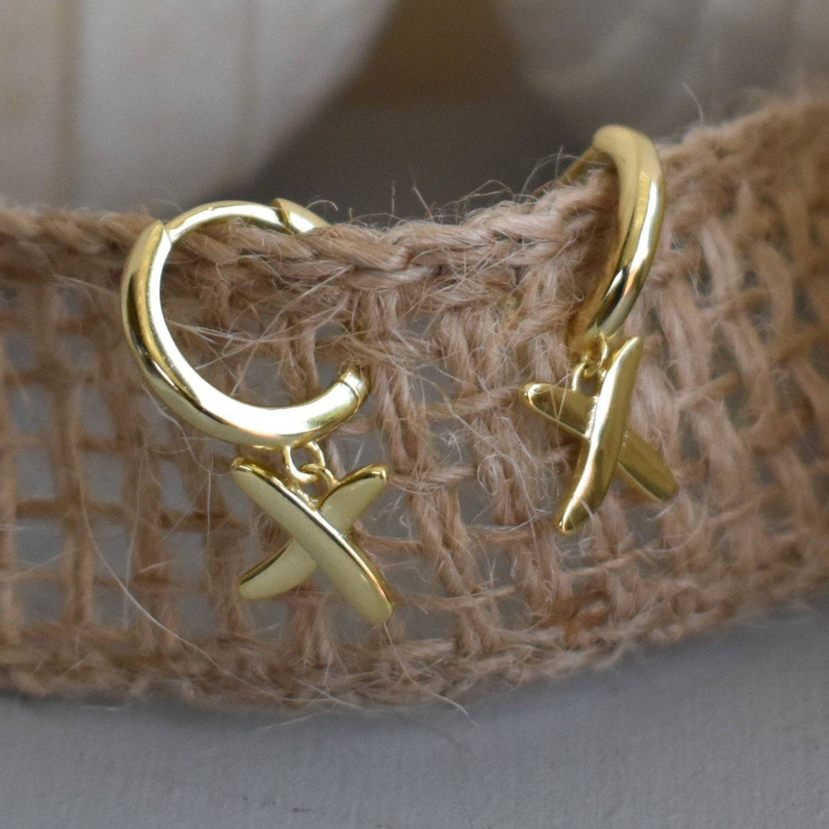 Huggie earrings to match our golden kisses necklace. 9mm huggies gold plated on sterling silver have a "kiss" dangling from each earring.