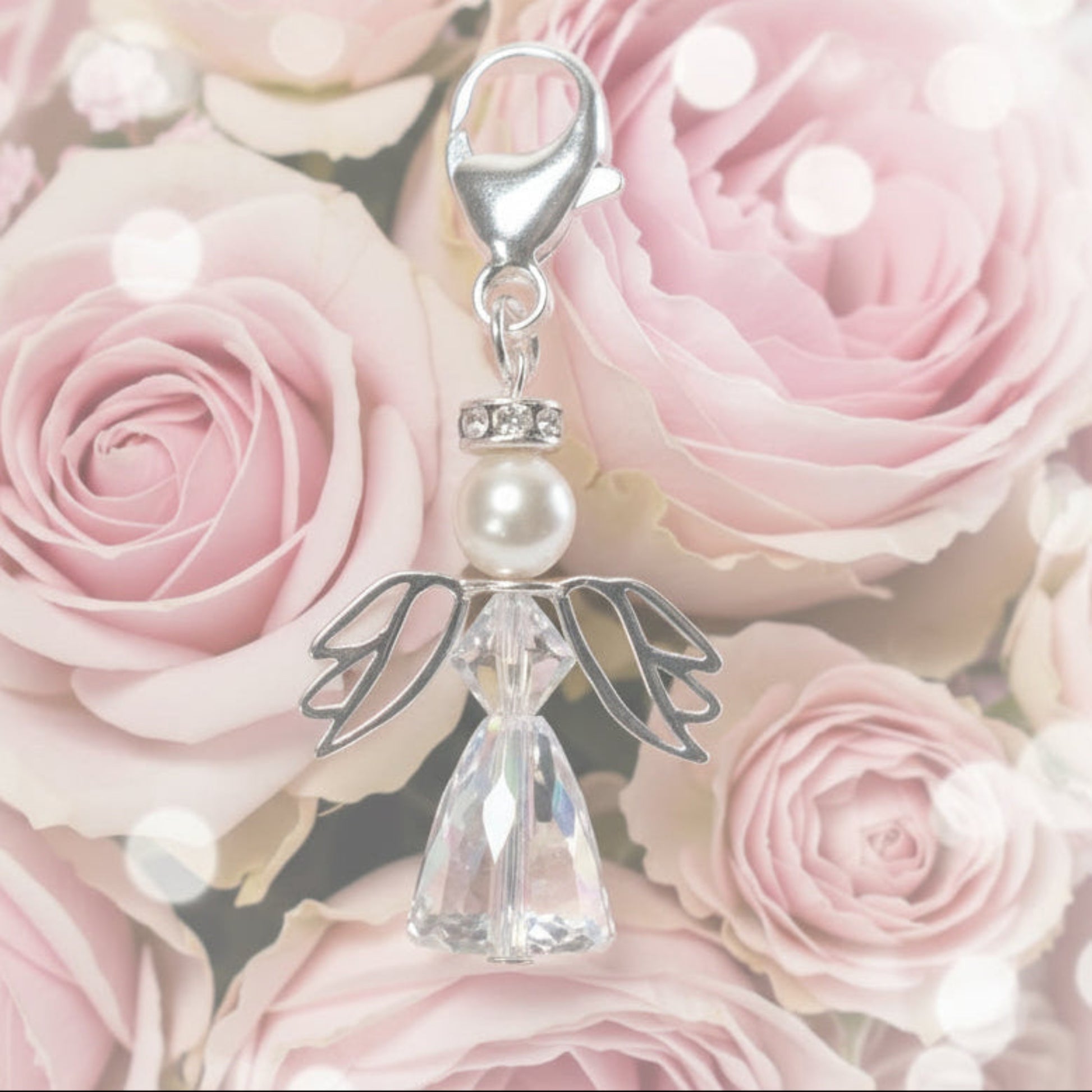 A crystal and pearl angel attached to a strong sterling silver caribiner
