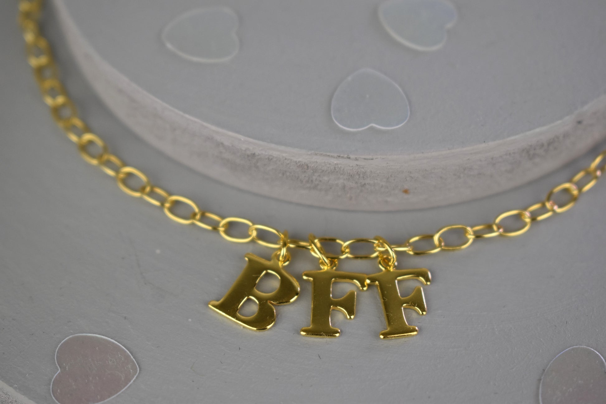 Model wears Necklace chain with and letters. Crafted with a 5.5mm link size chain in gold vermeil with serif letters spelling out  BFF (Best Friends Forever). Each letter is a classic serif uppercase font.