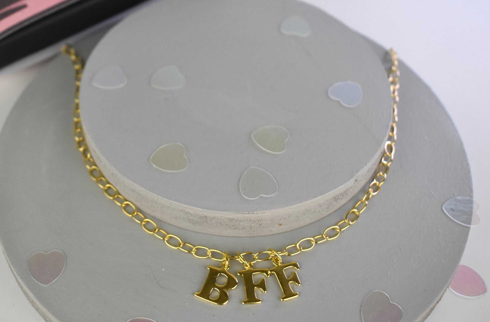 Model wears Necklace chain with and letters. Crafted with a 5.5mm link size chain in gold vermeil with serif letters spelling out  BFF (Best Friends Forever). Each letter is a classic serif uppercase font.