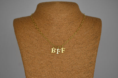 Model wears Necklace chain with and letters. Crafted with a 5.5mm link size chain in gold vermeil with serif letters spelling out  BFF (Best Friends Forever). Each letter is a classic serif uppercase font.