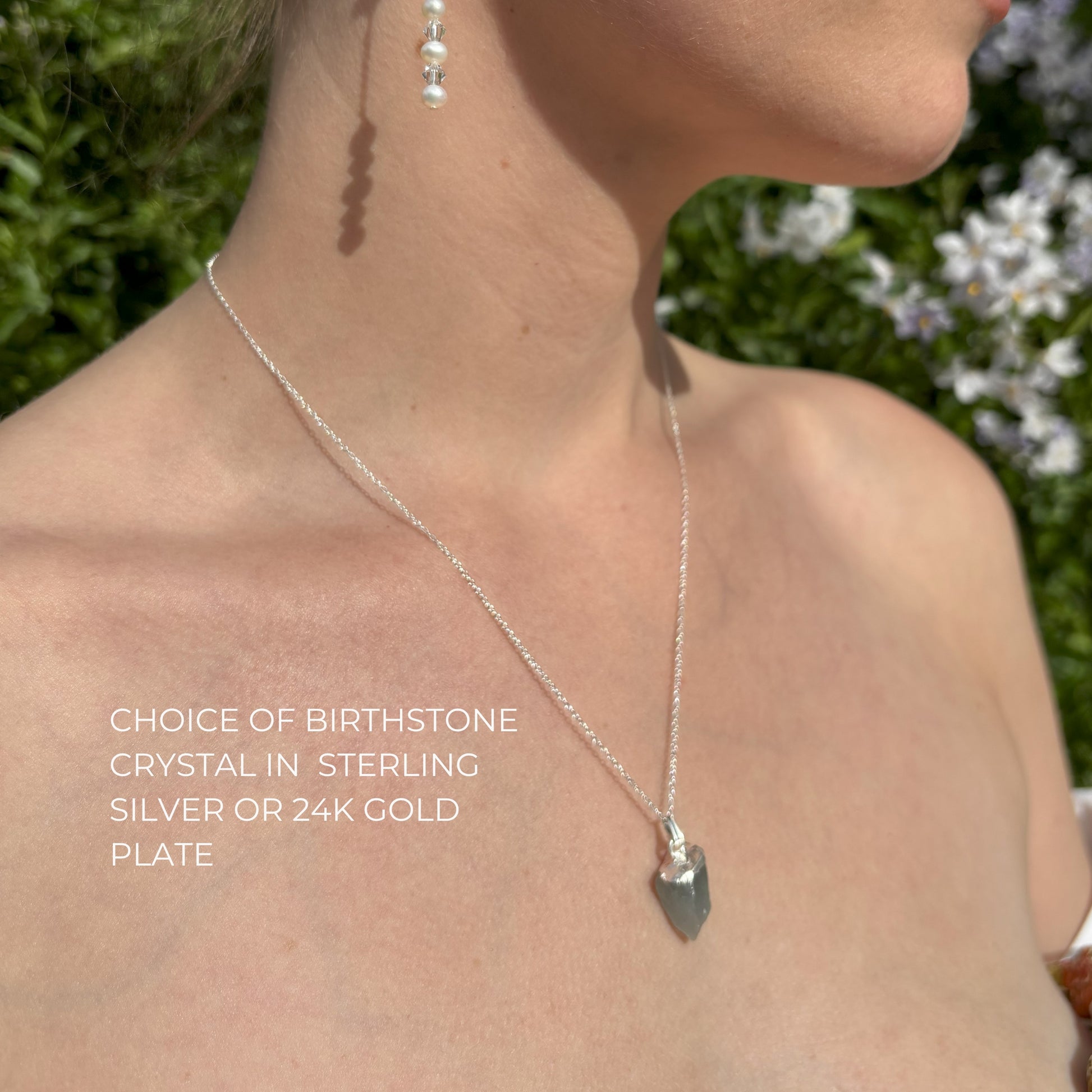 Model wears natural crystal pendant in silver