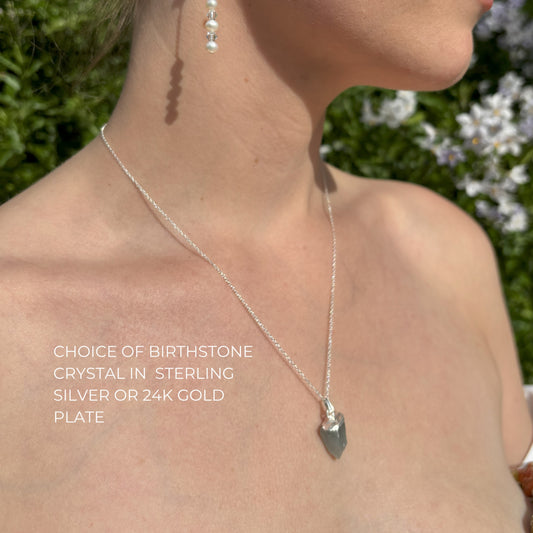 Model wears natural crystal pendant in silver