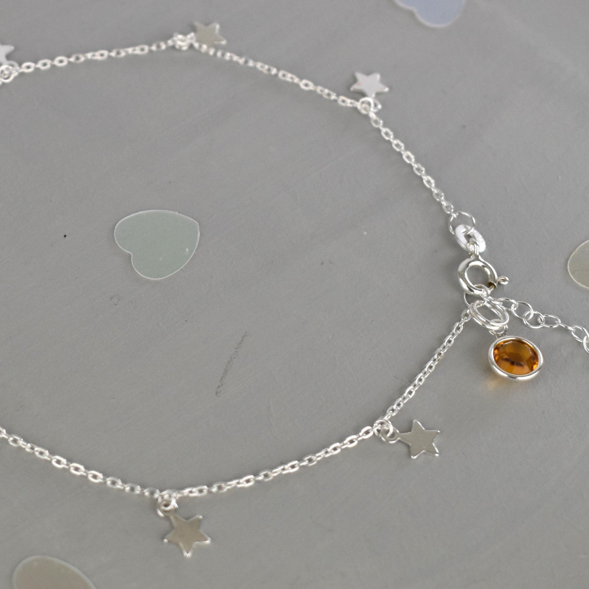 Boho Star Sterling Silver Anklet with Crystal Birthstone Charm. Crafted from sterling silver with flat cable chain links to sit comfortably. A secure fit, thanks to its 9 inch chain and a 1 inch extender.