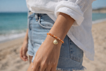 Model wears Carnelian elasticated bracelet with sterling silver gold plated shell
