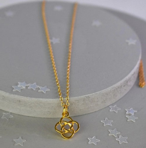 Celtic Knot Pendant Necklace shown in gold plated. A Celtic Knot charm hanging from a cable chain.