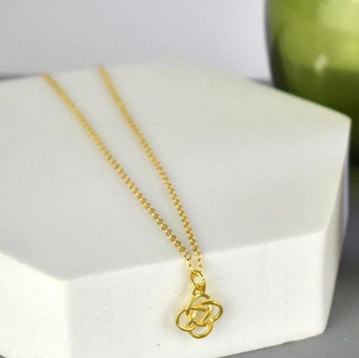 Celtic Knot Pendant Necklace shown in gold plated. A Celtic Knot charm hanging from a cable chain.