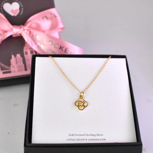 Celtic Knot Pendant Necklace shown in gold plated. A Celtic Knot charm hanging from a cable chain. Shown in gift box