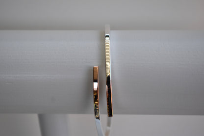 Sterling silver cross over bangle with rose gold tipped ends
