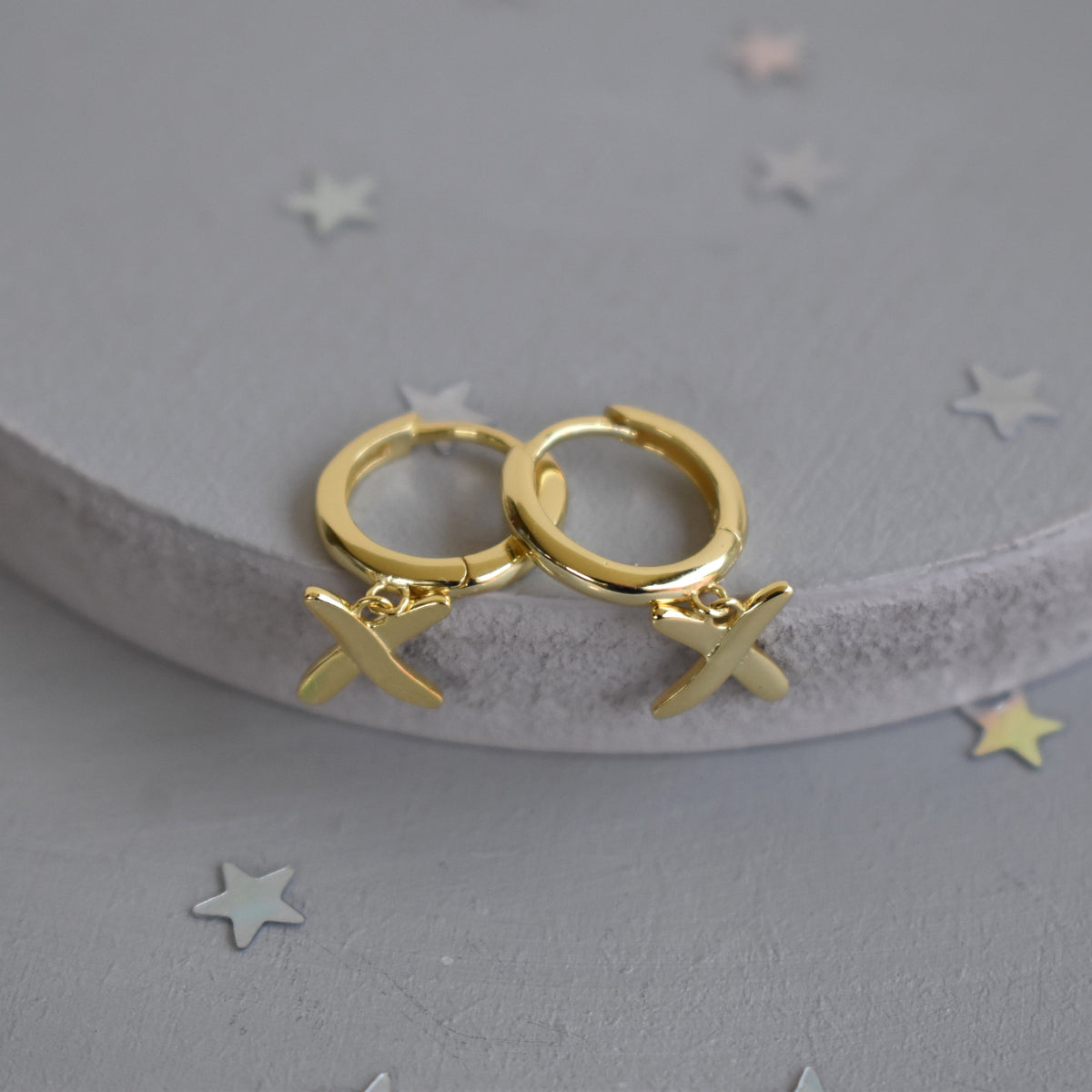 Huggie earrings to match our golden kisses necklace. 9mm  huggies gold plated on sterling silver have a "kiss" dangling from each earring.