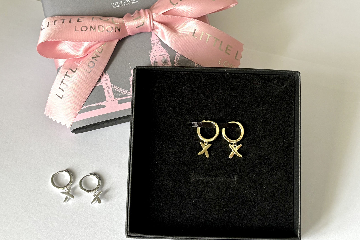 Huggie earrings to match our golden kisses necklace. 9mm  huggies gold plated on sterling silver have a "kiss" dangling from each earring.