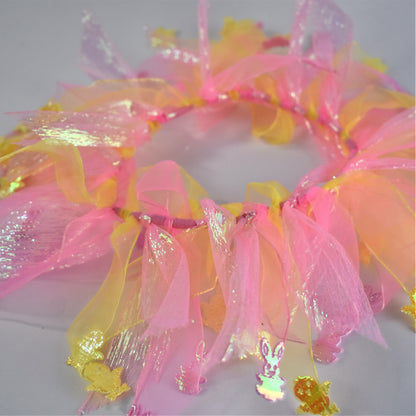 Worn by medium size cockapoo. Fun elastic frill for dogs. Pastel pink and yellow tulle frills with foil pink rabbits and yellow chicks on the end of each tulle frill. One size.