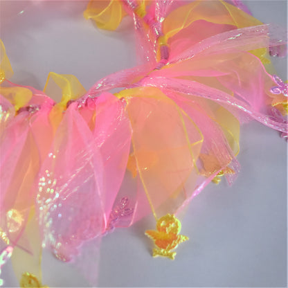 Worn by medium size cockapoo. Fun elastic frill for dogs. Pastel pink and yellow tulle frills with foil pink rabbits and yellow chicks on the end of each tulle frill. One size.