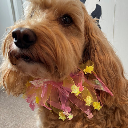 Worn by medium size cockapoo. Fun elastic frill for dogs. Pastel pink and yellow tulle frills with foil pink rabbits and yellow chicks on the end of each tulle frill. One size.