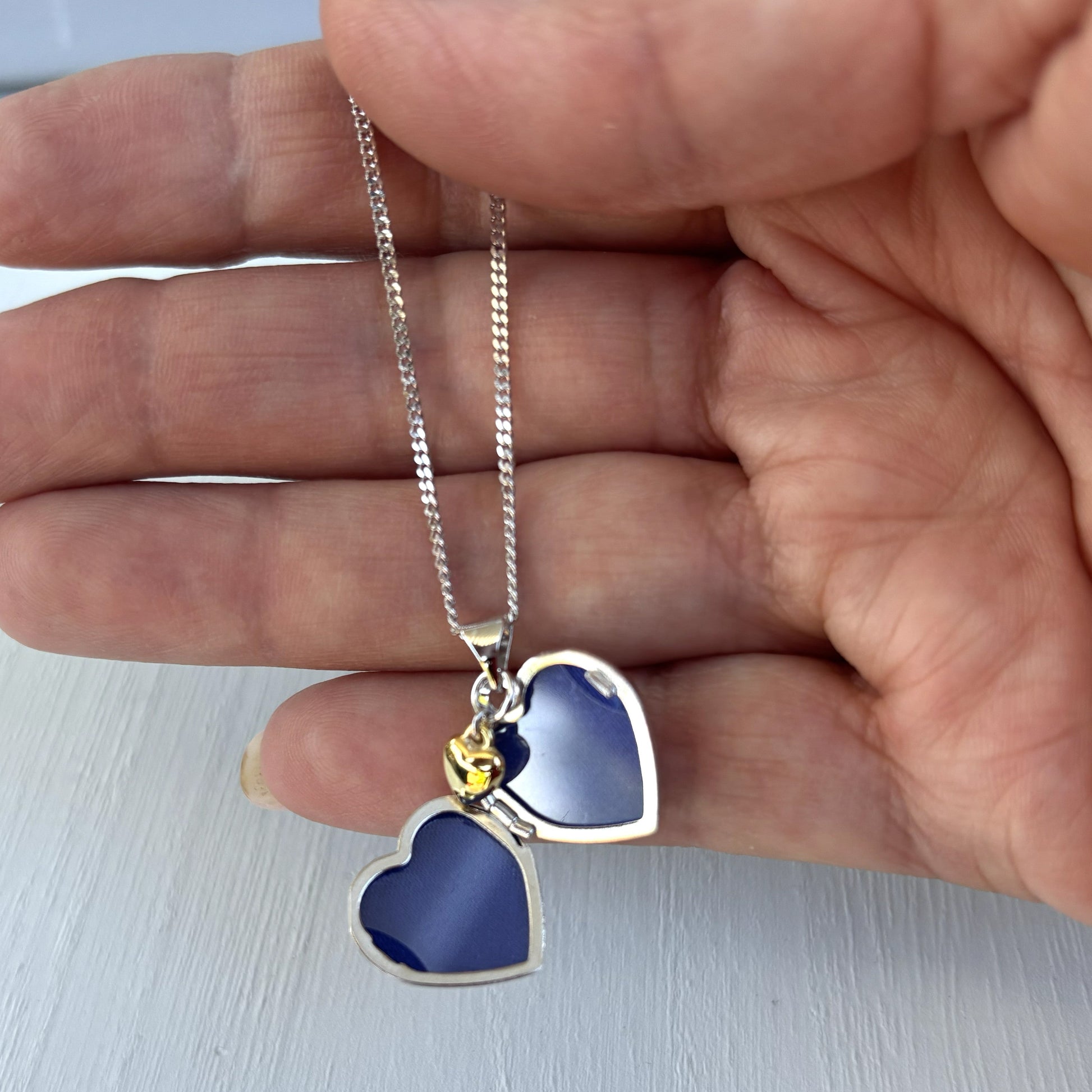 Personalised Sterling Silver & Gold Plated Diamond Heart Locket Necklace features a small inset diamond shown open and in hand for sizing