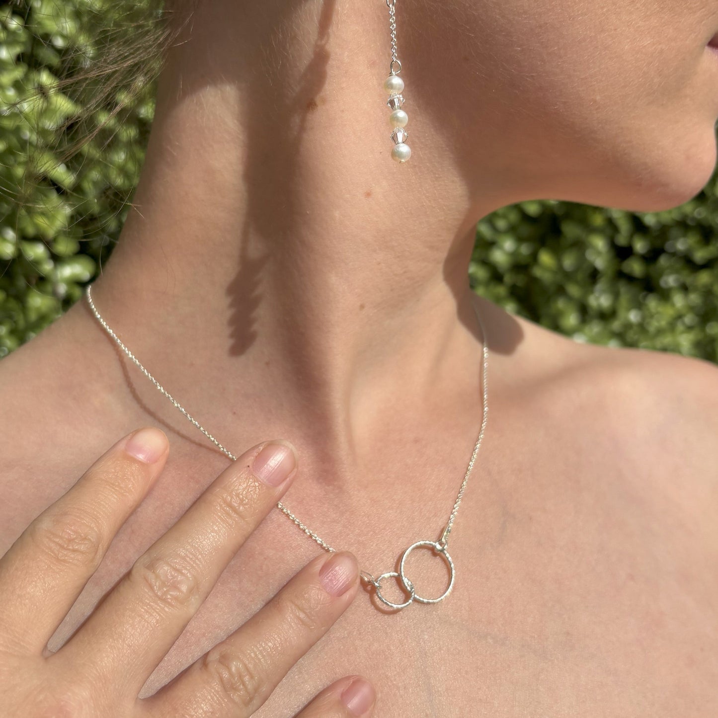 Sterling silver sparkly entwined circles shown on sterling silver chain.