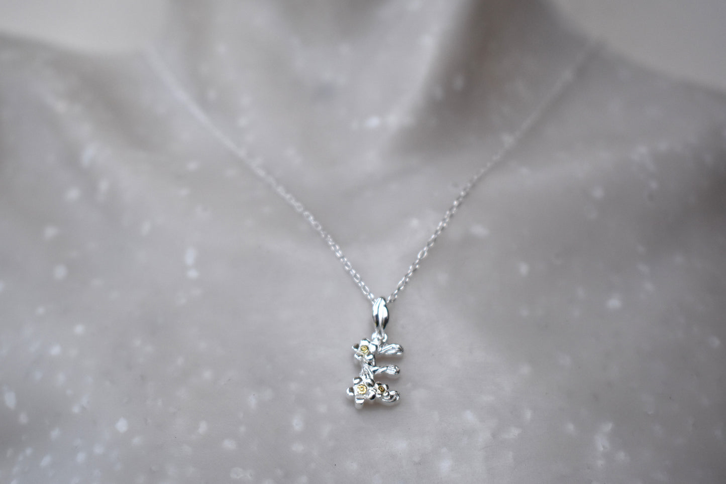 Alphabet Initial Pendant in two-tone sterling silver and 18ct yello gold plate shown with optional sterling silver and premium crystal birthstone