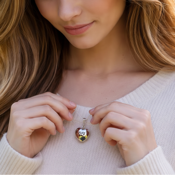 Woman wears Heart-shaped paw print opening photo locket on sterling silver chain