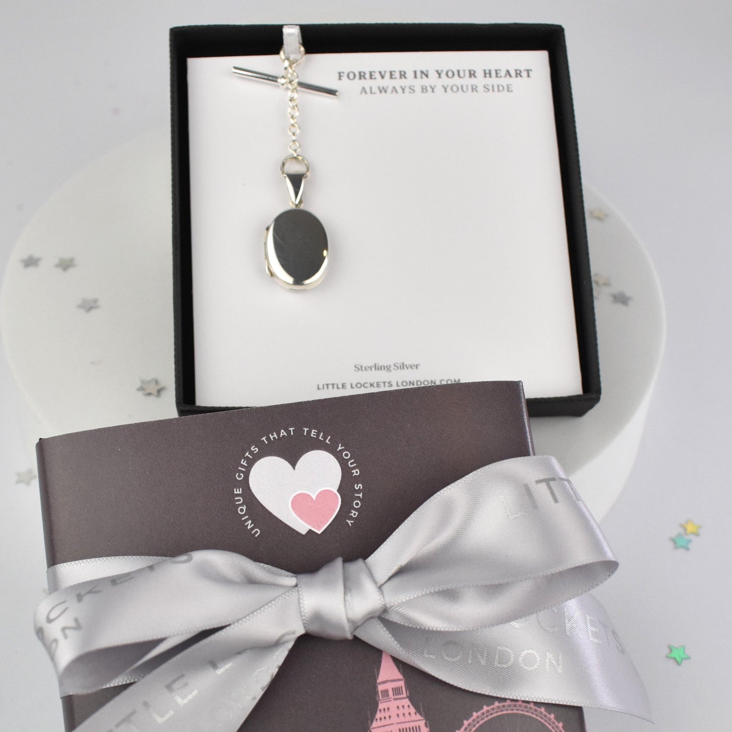 Sterling silver oval photo pocket locket shown in gift box mounted on gift card with optional ribbon and london sleeve