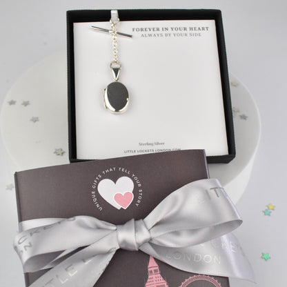 Sterling silver oval photo pocket locket shown in gift box mounted on gift card with optional ribbon and london sleeve