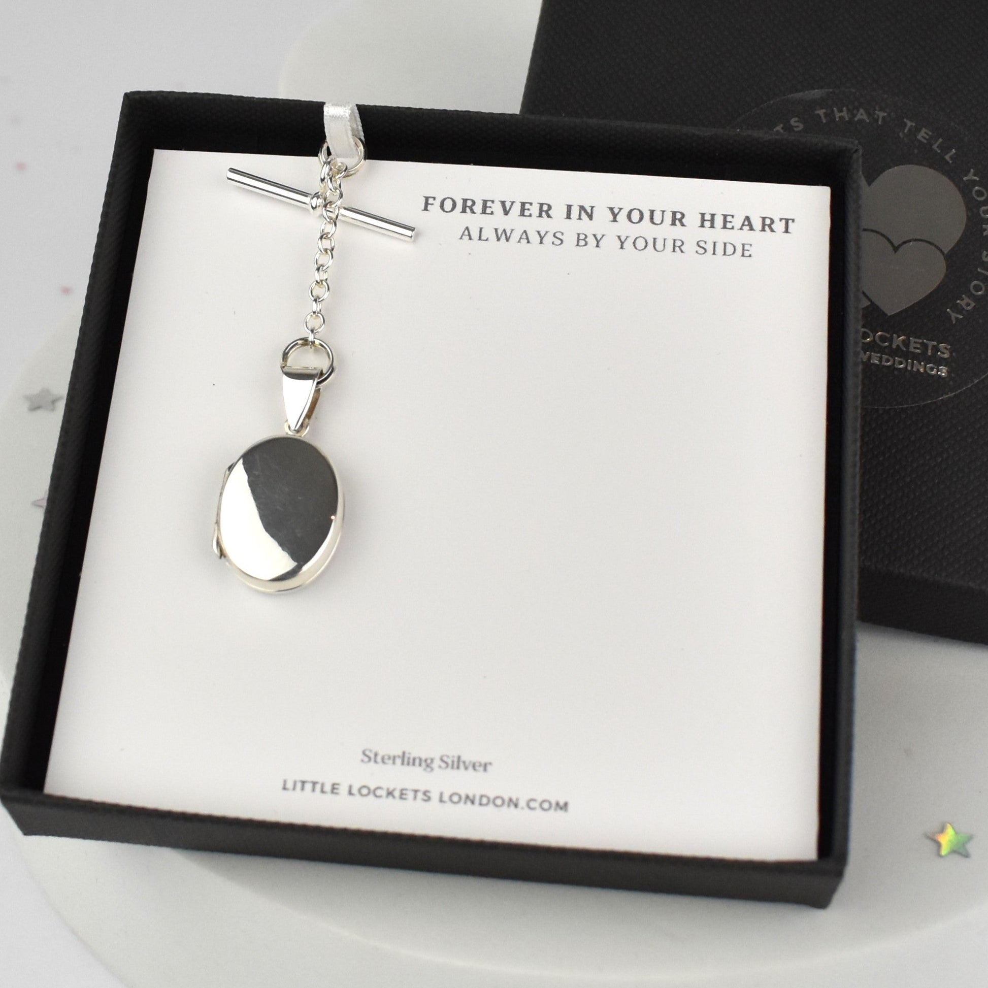 Oval locket mounted on gift card in gift box