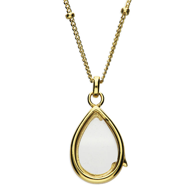 A gold peare shape glass locket for charms, suspended from a gold beaded chain.