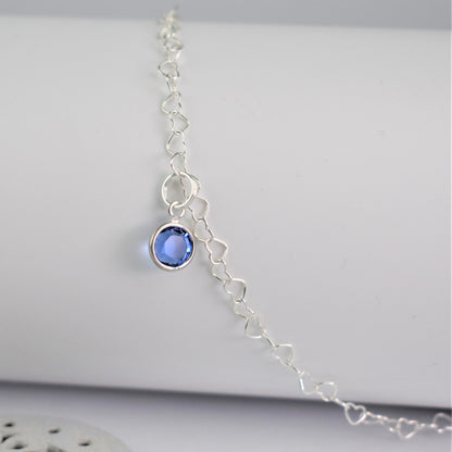 Close up of Sterling Silver heart link anklet with something blue sapphire crystal charm