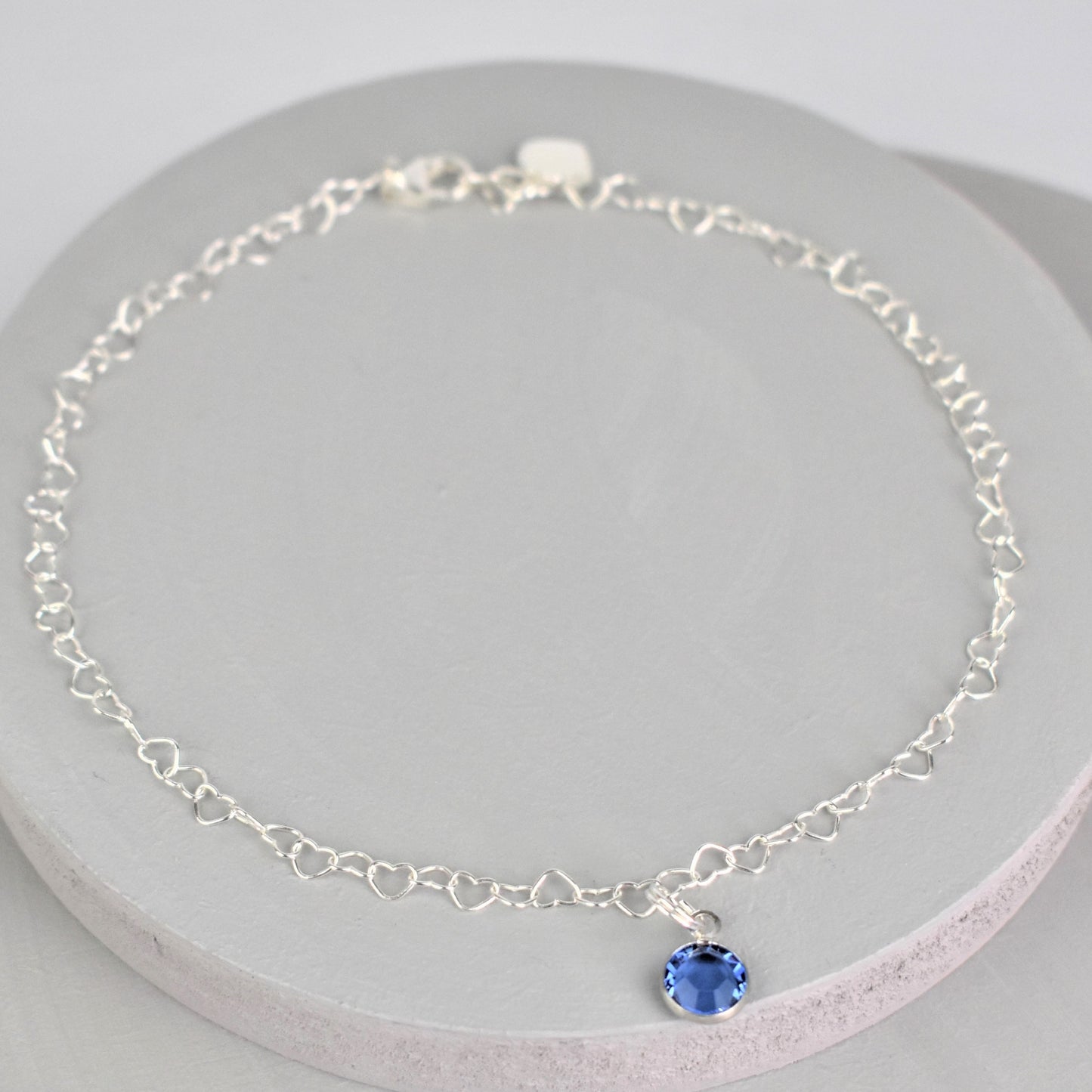 Sterling silver heart link anklet with something blue crystal charm