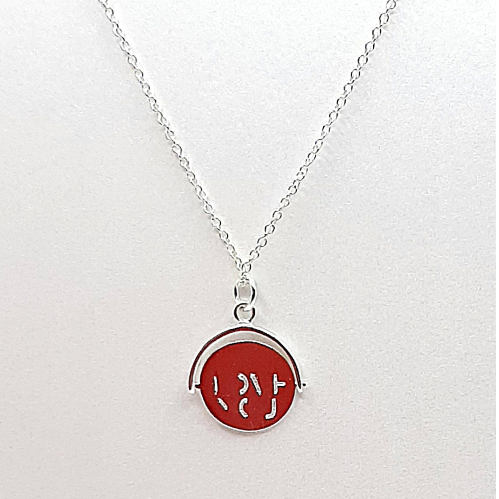Sterling silver disc which when spun forms the words "I LOVE YOU"