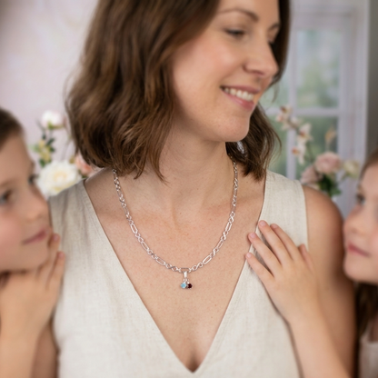 Model wears Sterling silver necklace of linked infinity symbols hung with birthstones of your choice