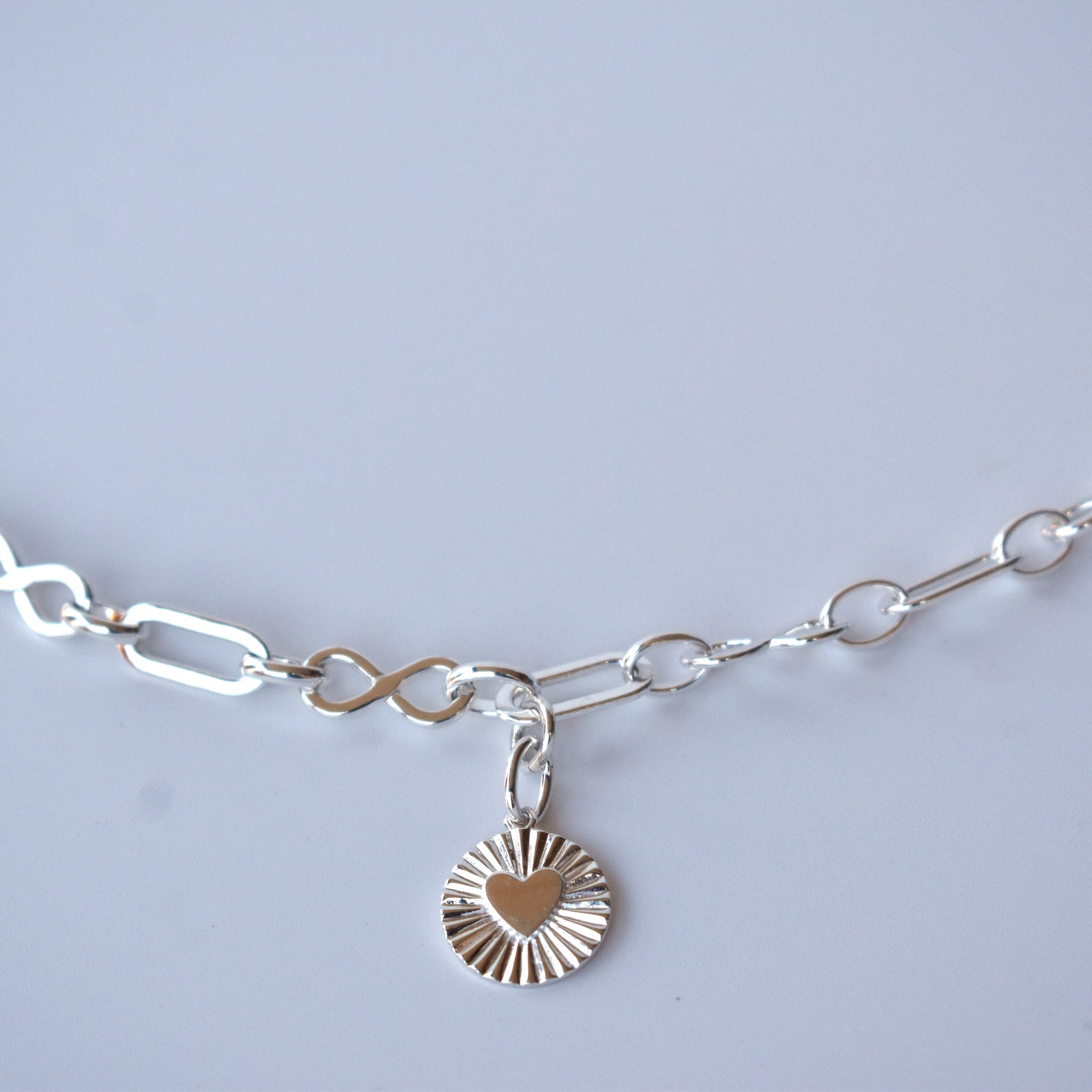 Sterling silver infinity link necklace with sunburst pendant