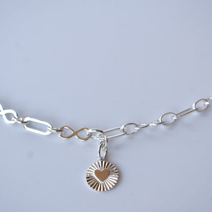Sterling silver infinity link necklace with sunburst pendant