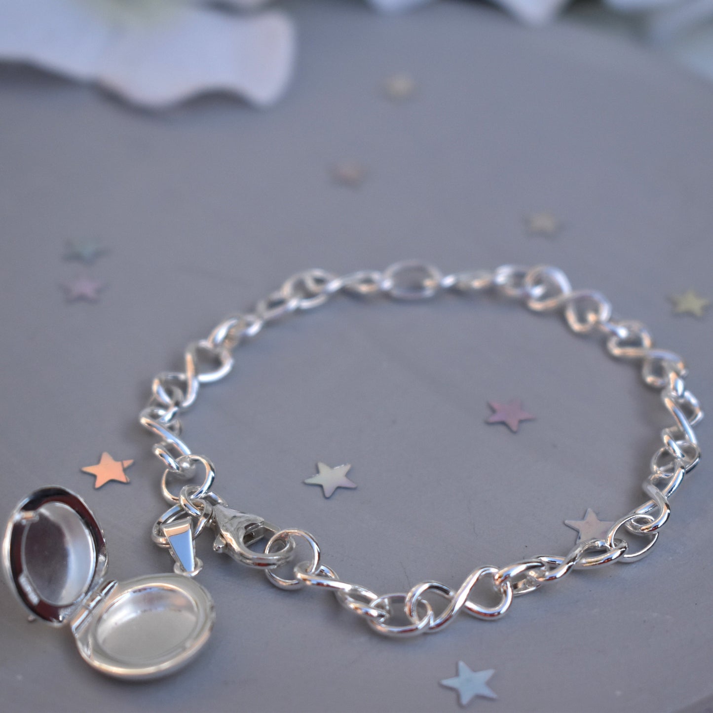 Sterling silver miniature locket on infinity link bracelet