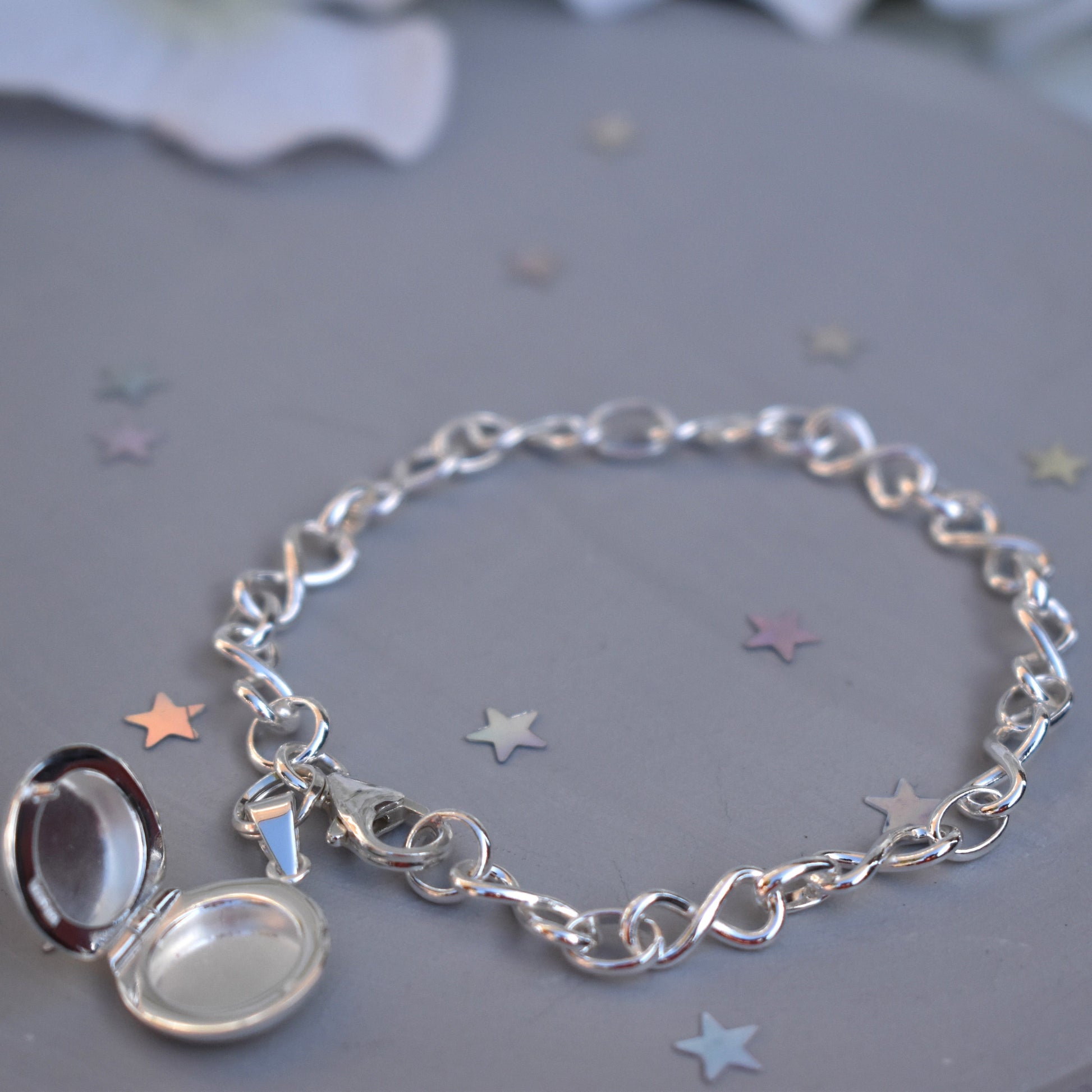 Sterling silver miniature locket on infinity link bracelet