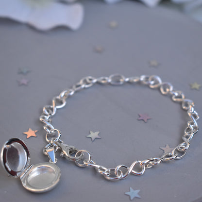 Sterling silver miniature locket on infinity link bracelet