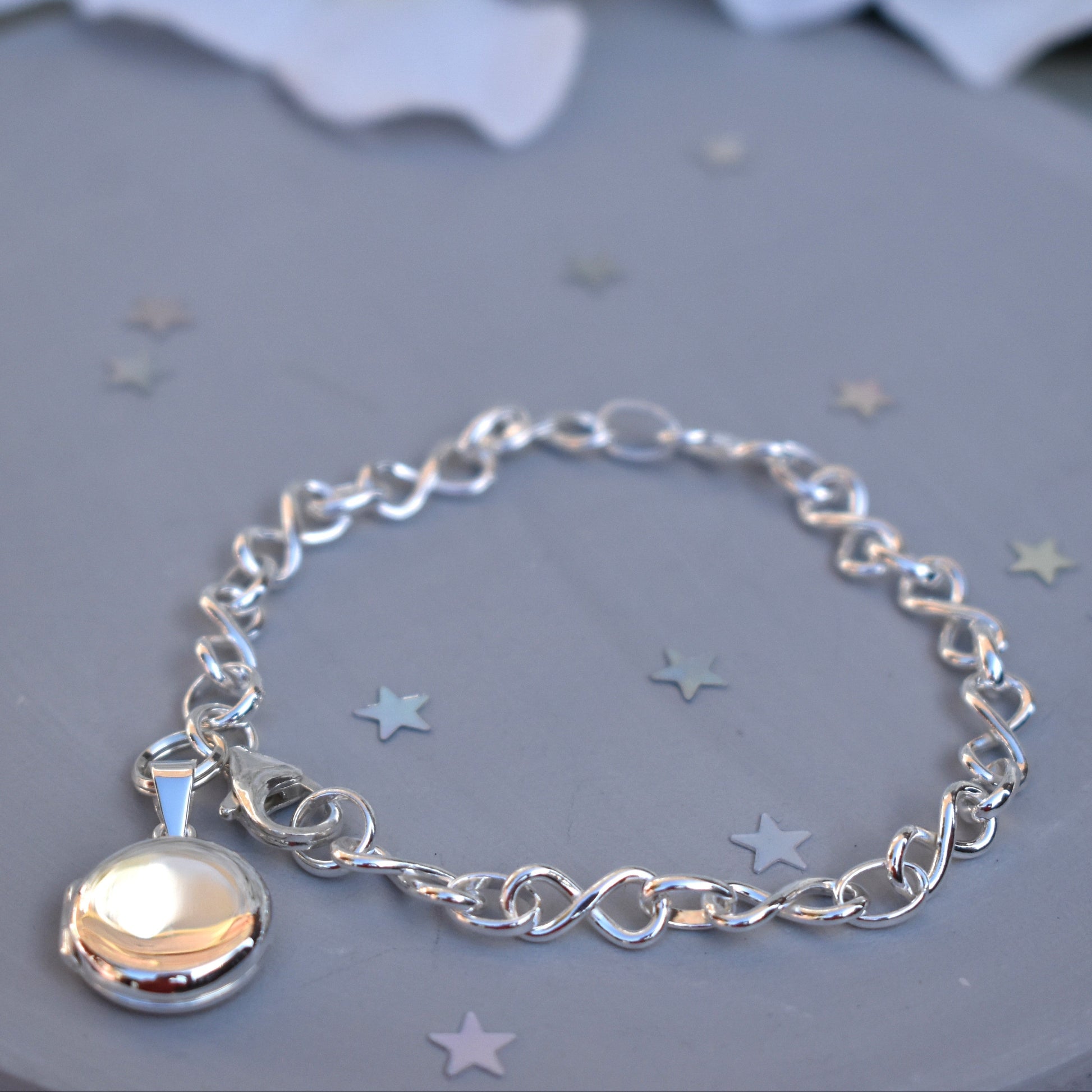 Sterling silver miniature locket on infinity link bracelet