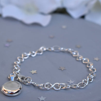 Sterling silver miniature locket on infinity link bracelet