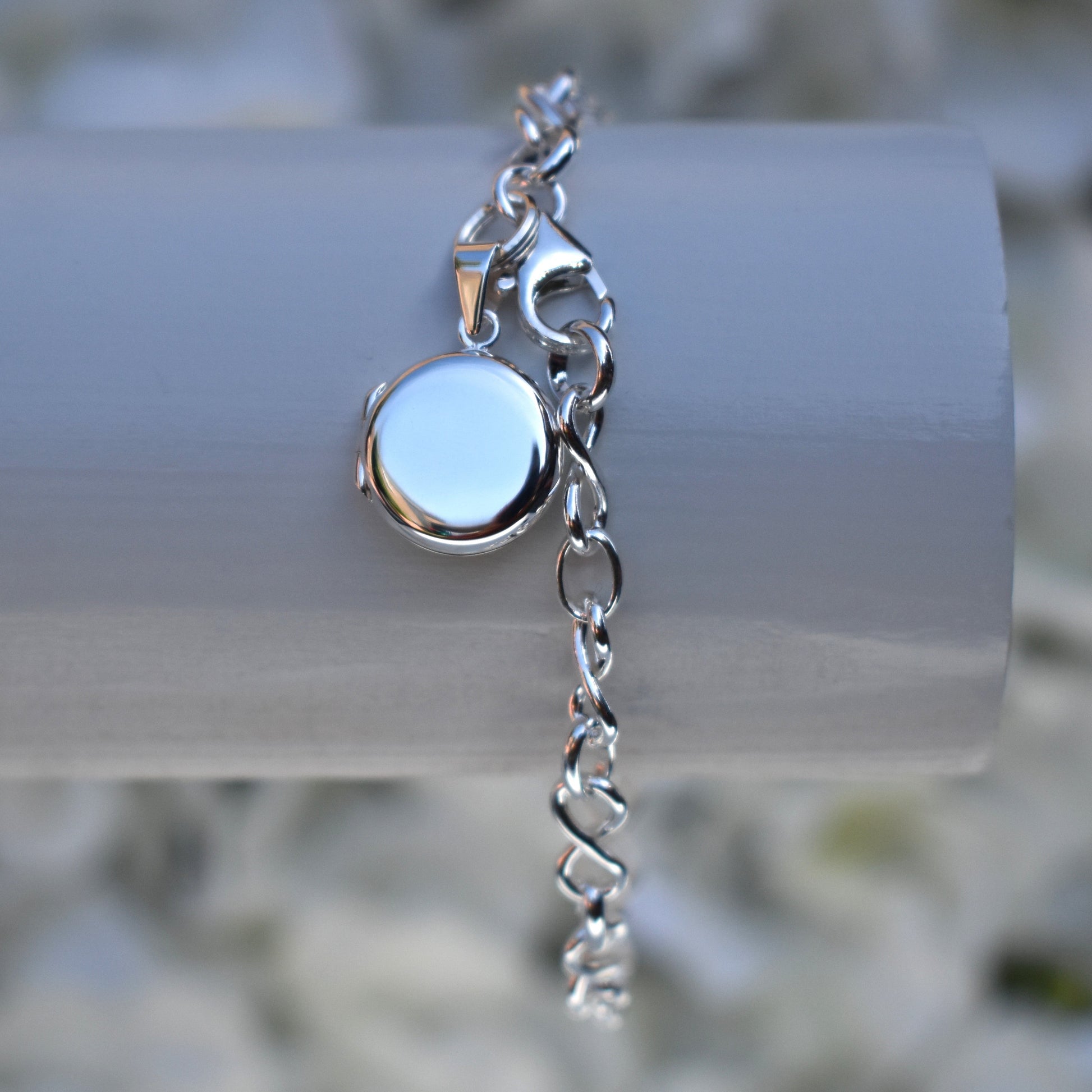 Sterling silver miniature locket on infinity link bracelet