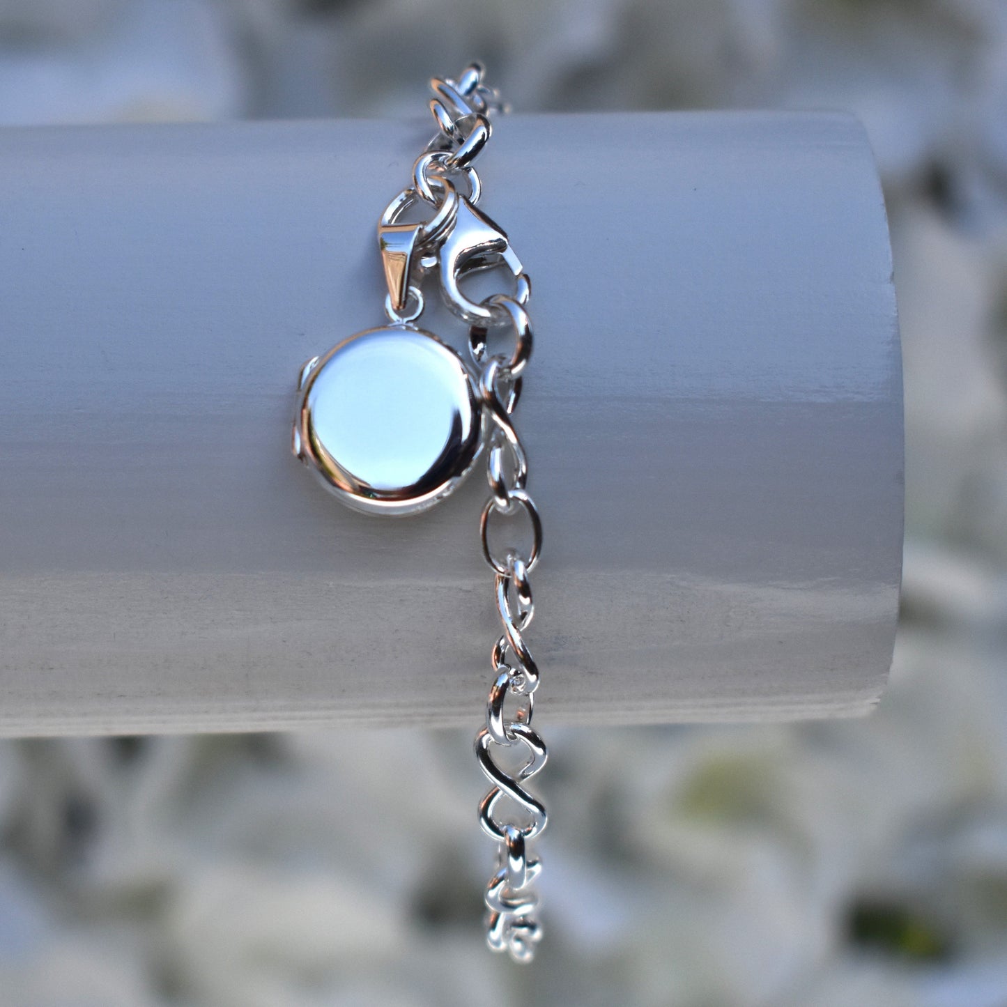 Sterling silver miniature locket on infinity link bracelet