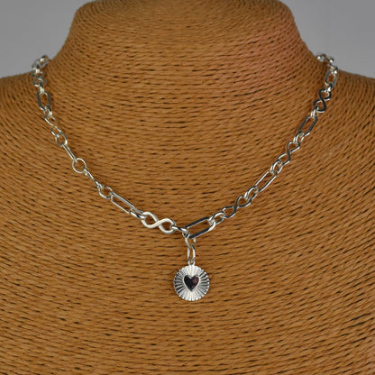 Sterling Silver Handmade Flat Link Infinity Necklace featuring a Heart Rays Pendant. Showcases flat oval and infinity links and features a Sterling Silver Sunburst Heart Rays charm pendant surrounded by an intricate sun rays design