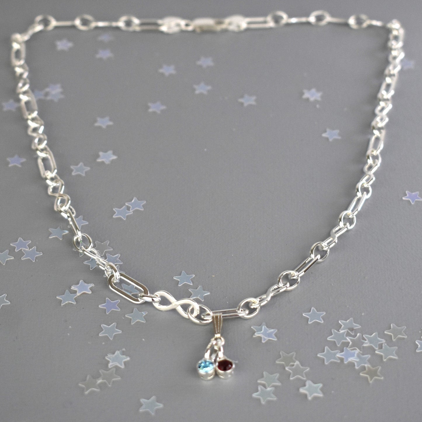 Sterling silver necklace of linked infinity symbols hung with birthstones of your choice