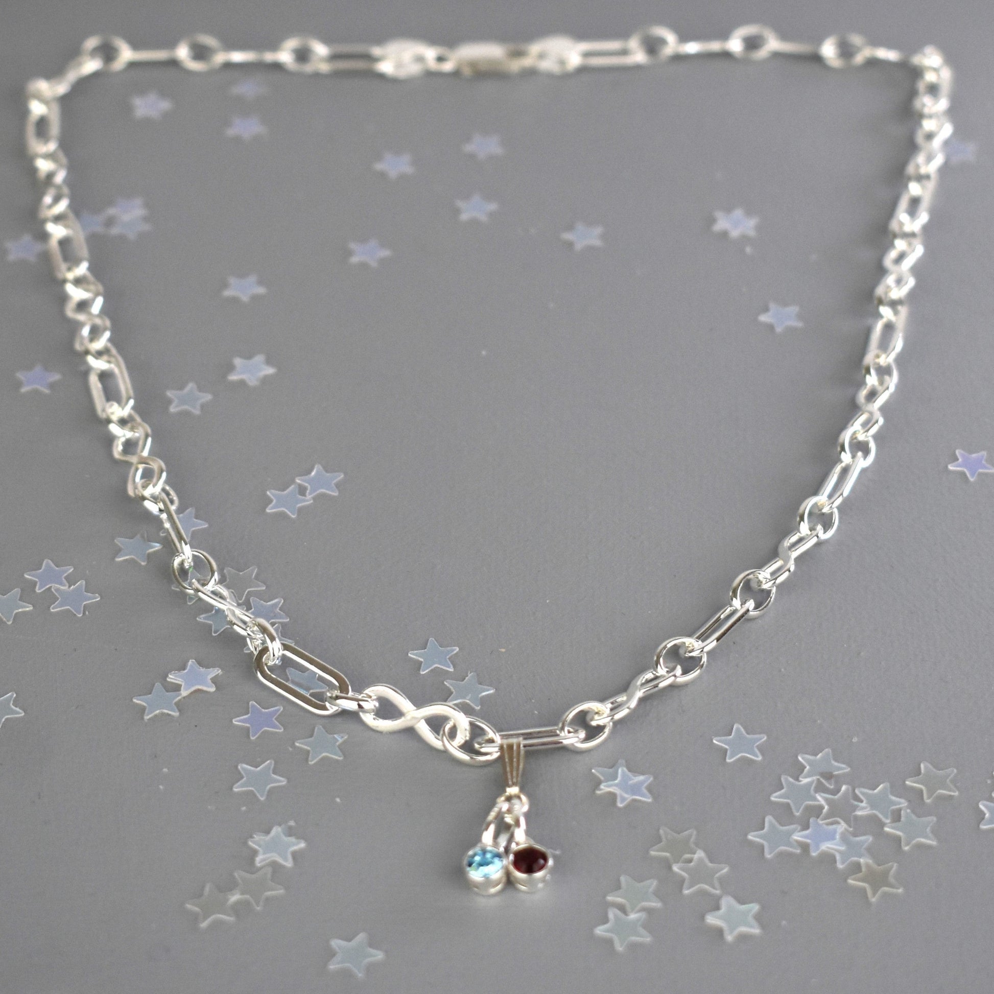 Sterling silver necklace of linked infinity symbols hung with birthstones of your choice