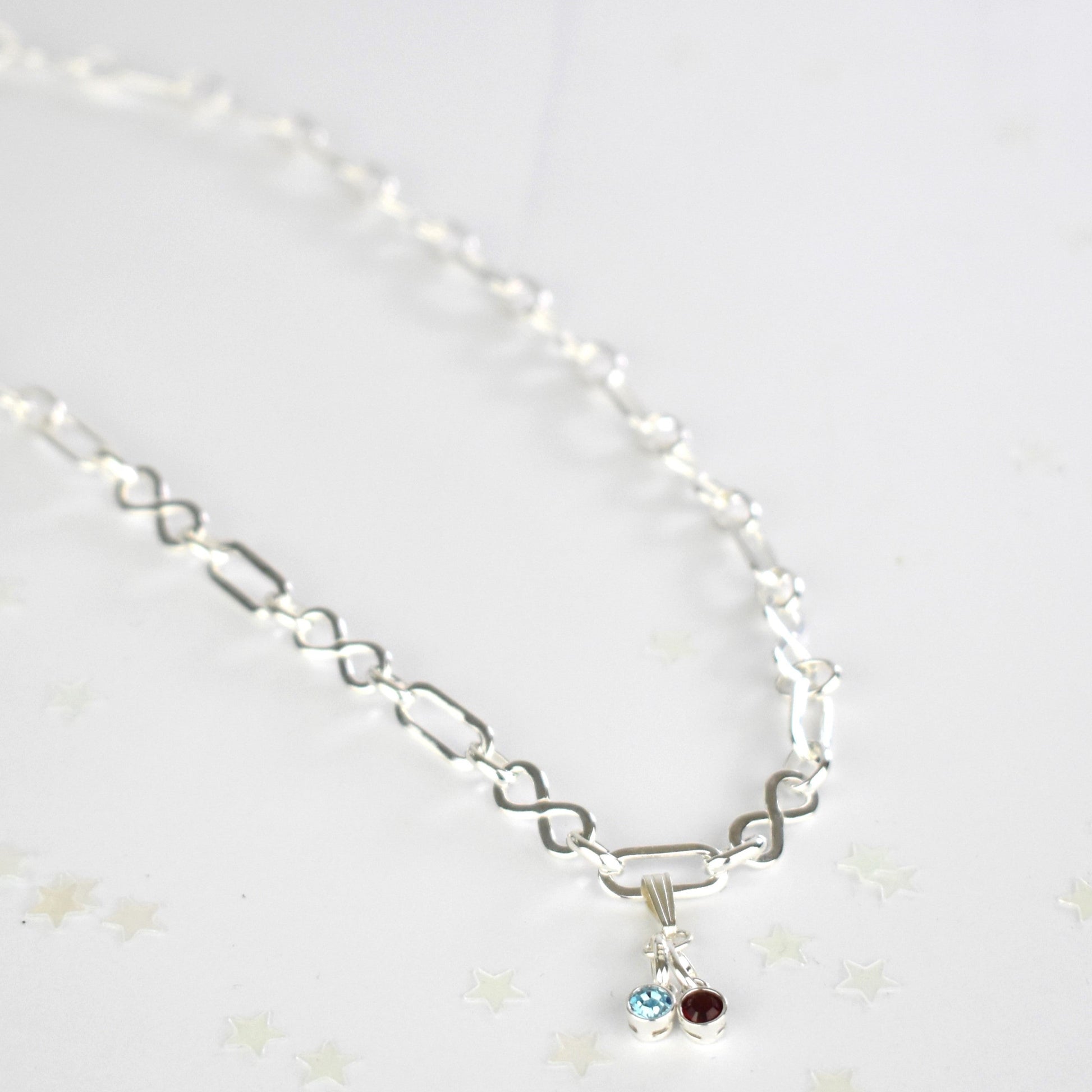 Sterling silver necklace of linked infinity symbols hung with birthstones of your choice