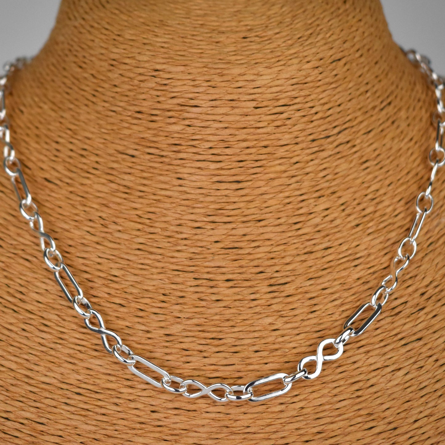 Sterling silver necklace of linked infinity symbols 