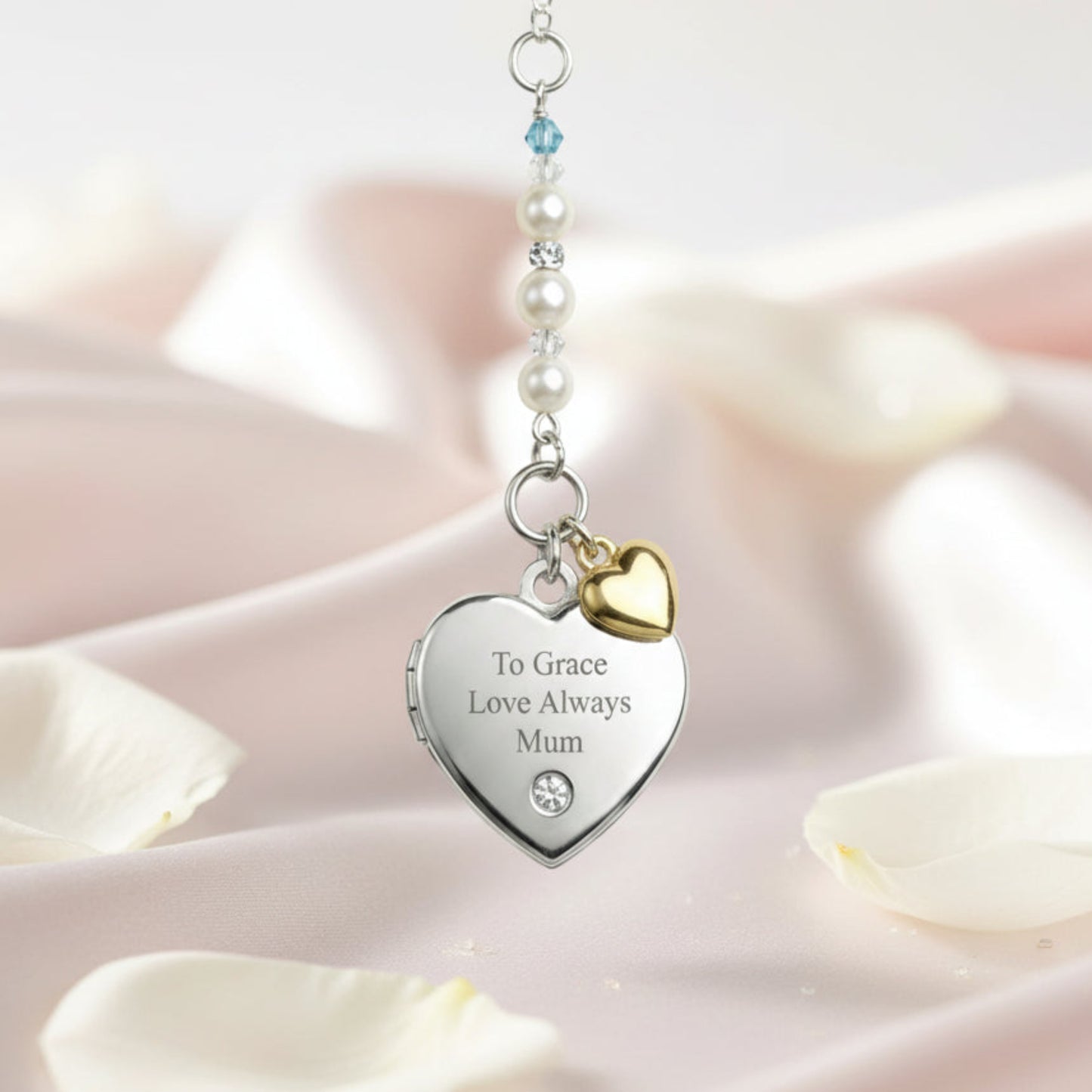 Sterling silver engraved locket, with tiny gold plated sterling silver heart and your choice of wording engraved on the front. Suspended from a line of high quality Austrian crystals and pears with a tiny blue bead as a something blue