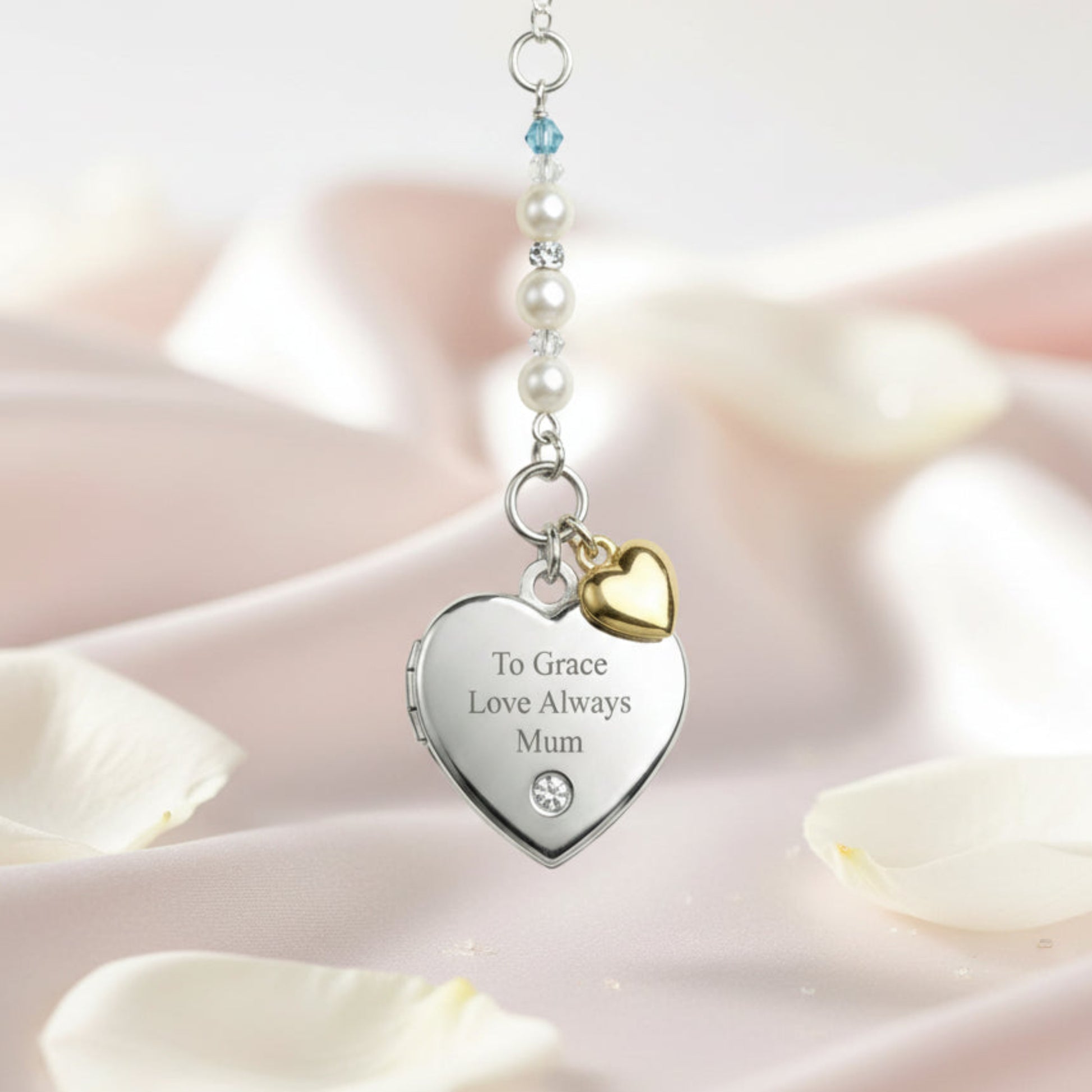 Sterling silver engraved locket, with tiny gold plated sterling silver heart and your choice of wording engraved on the front. Suspended from a line of high quality Austrian crystals and pears with a tiny blue bead as a something blue