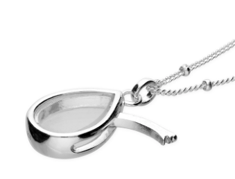 Sterling silver glass locket shown with side opening to insert charms or tiny crystals.