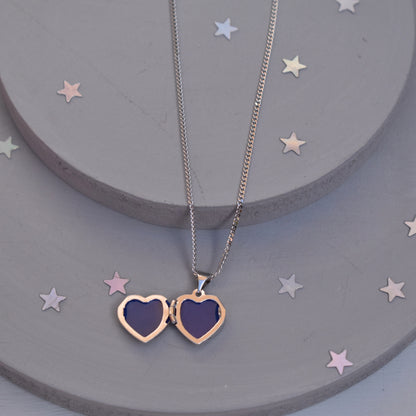 Heart-shaped paw print opening photo locket on sterling silver chain shown open  with photo apertures