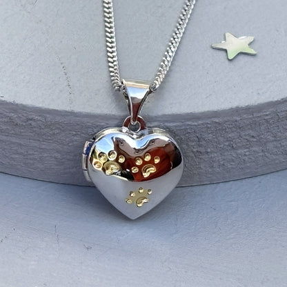 Close up of Heart-shaped paw print opening photo locket on sterling silver chain