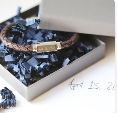 A brown twisted leather bracelet with a stainless steel central plate with your engraving